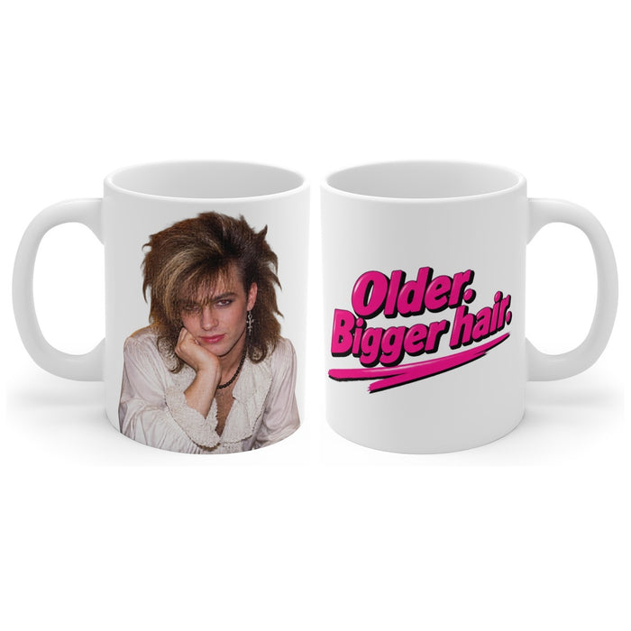 Older. Bigger hair. mug, handle right