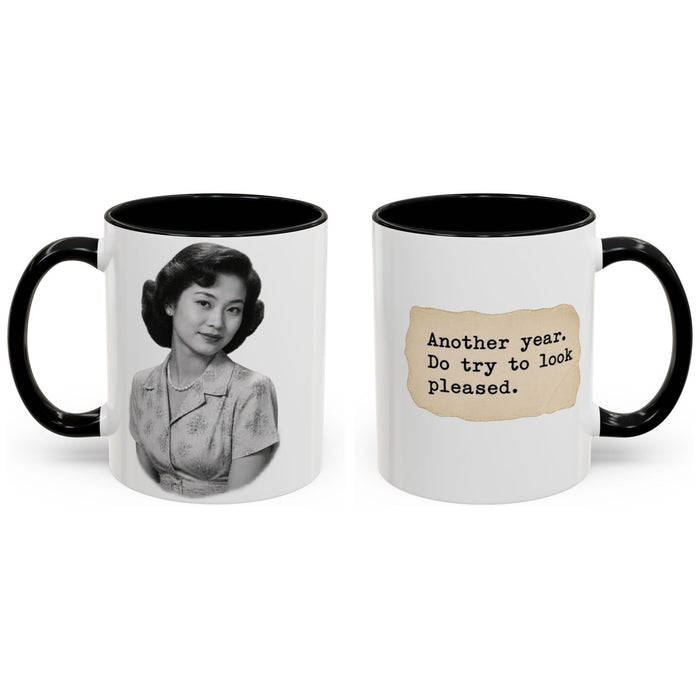 Another year. Do try to look pleased. mug, 11oz white ceramic, black handle and interior, handle right